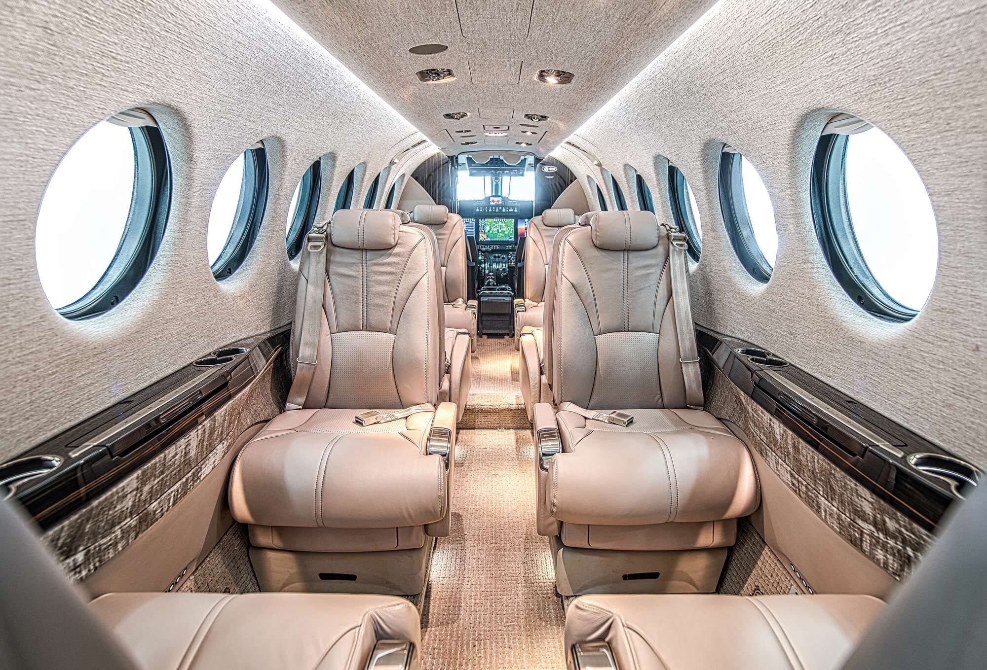 Cessna Grand Caravan on a dirt bush strip, golf travel bags on the apron